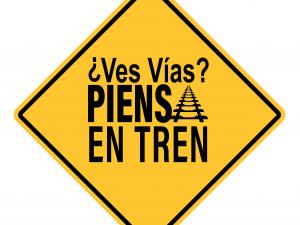 a yellow sign logo with spanish slogan
