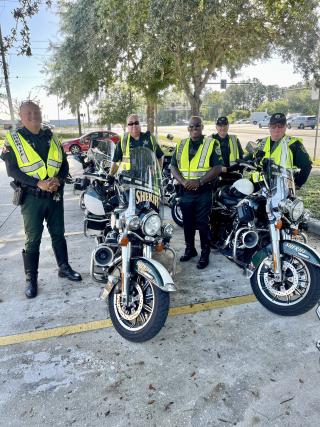 policemen standing near their motorcycles
